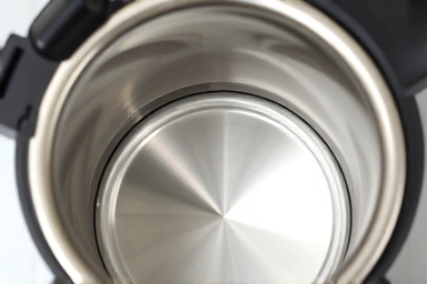 Clean stainless steel interior of a travel electric kettle.