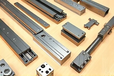 Various drawer slides on a workbench, showcasing different types.