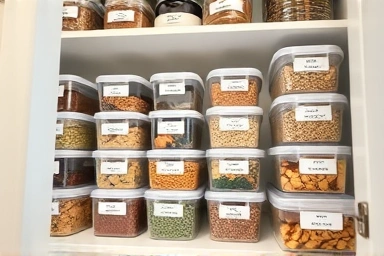 Neatly stacked and labeled storage containers in pantry