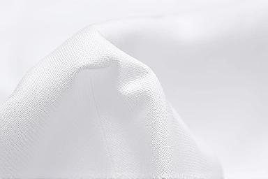 Close-up texture of seersucker fabric, showing air pockets.