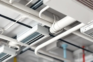 Abstract view of hidden ceiling work for air conditioner installation.