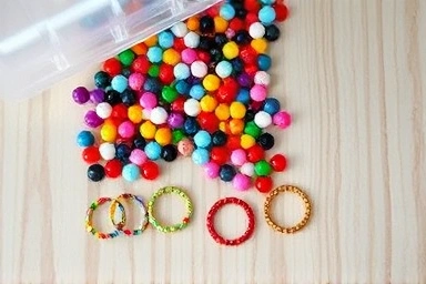 Colorful beads and handmade rings artfully arranged.