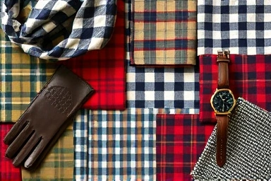 Assortment of check pattern fabrics and elegant fashion accessories.