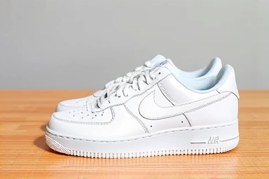 Iconic white Nike Air Force 1 sneakers on a wooden surface.