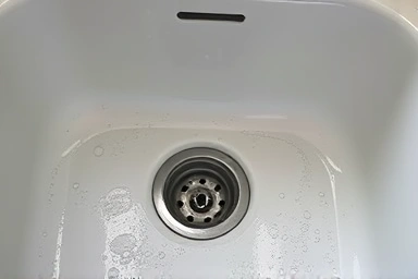 Sparkling clean kitchen sink after move-out cleaning.