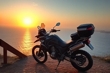 Motorcycle and camping gear at a scenic coastal sunset overlook