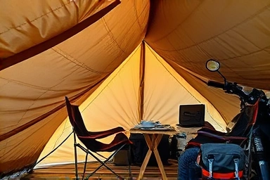 Cozy motorcycle camping setup with a functional tarp.