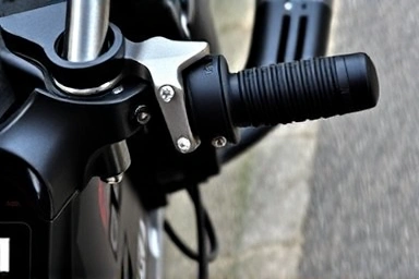 Close-up of motorcycle brake lever being squeezed firmly