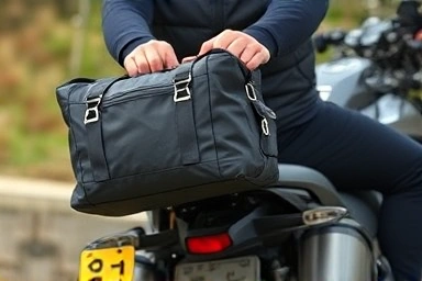 Rider attaching gear to motorcycle rear carrier