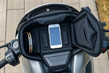 Organized motorcycle tank bag with smartphone mount, ready for travel.