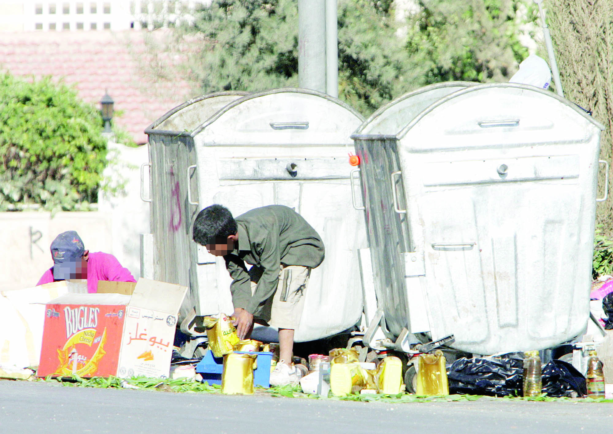طفلان يعملان في جمع الخردة بأحد شوارع عمان - (الغد)