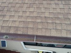 Granules in rain gutter from an older asphalt shingle roof