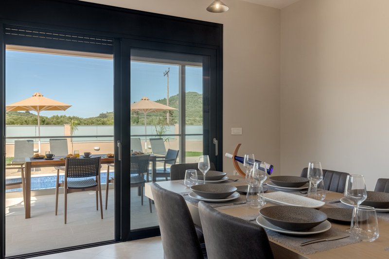 Amelia Residence Zakynthos, dining table with a yard view