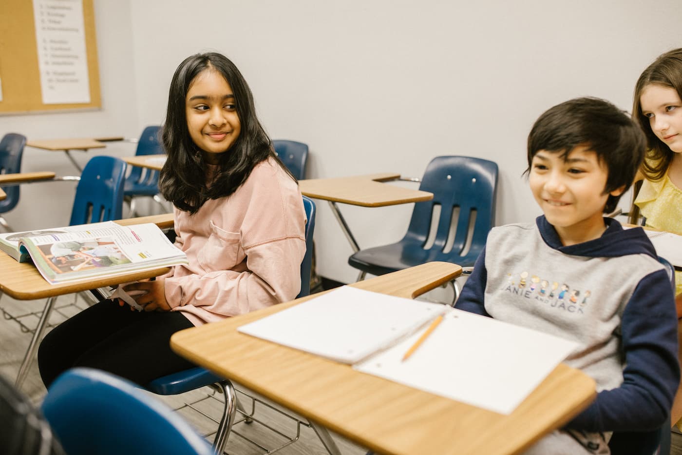 Class one student smiles at her friend