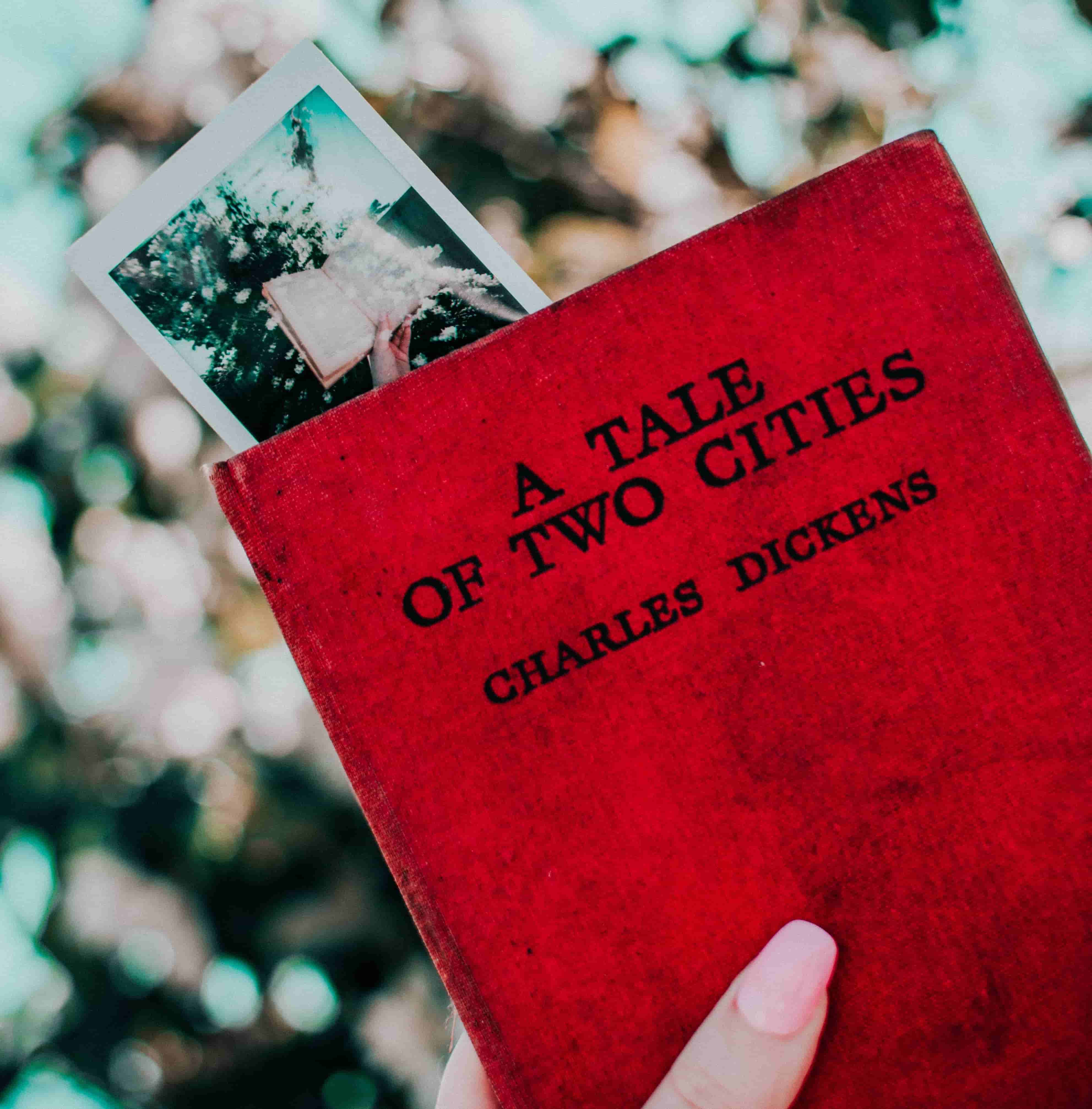 Girl holding a tale of two cities book