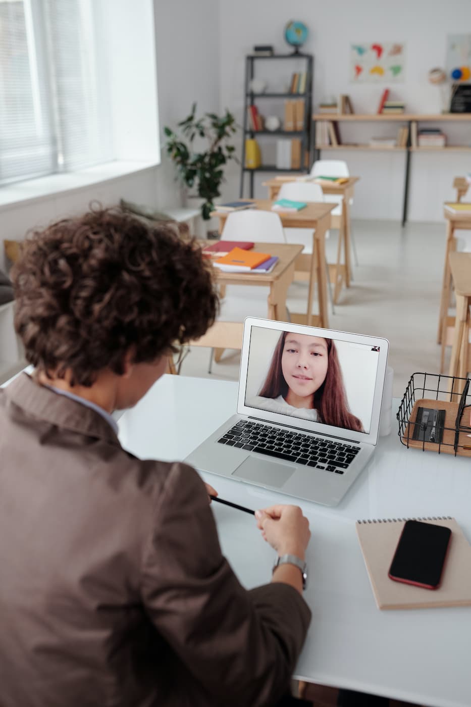 teacher listening to student online remote class