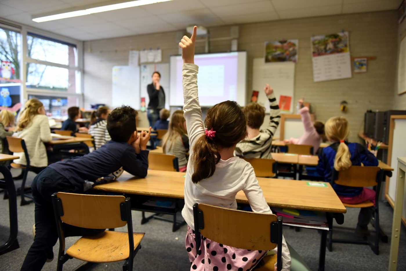 Student raising hand for question & attention