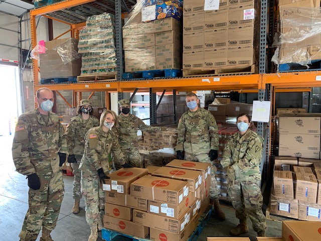 Indiana National Guard standing around some boxes