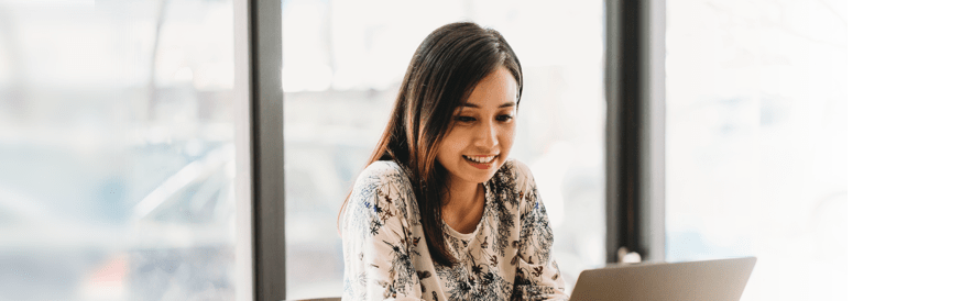 a cheerful virtual receptionist working on a laptop