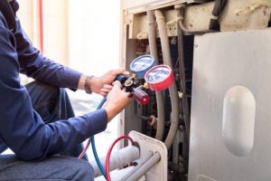 Technician is checking air conditioner ,measuring equipment for filling air conditioners.