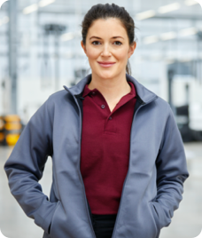 a young woman in grey jacket smiling at the camera