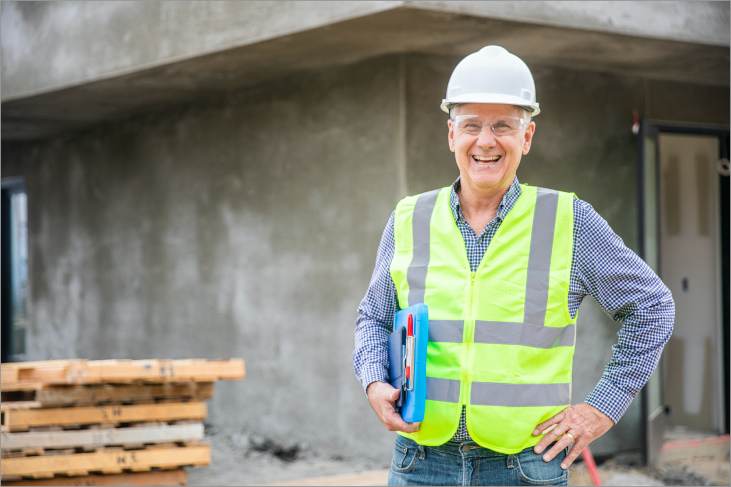 a smiling home inspector in safety gears