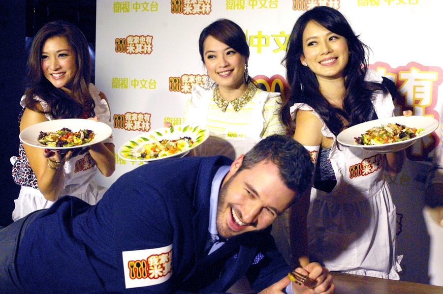 三位台灣「嬌妻」高伊玲、Melody及李詠嫻，將做好的沙拉放在帥哥主廚哈克曼身上，笑得他合不攏嘴。（photo by 陳正健/台灣醒報）