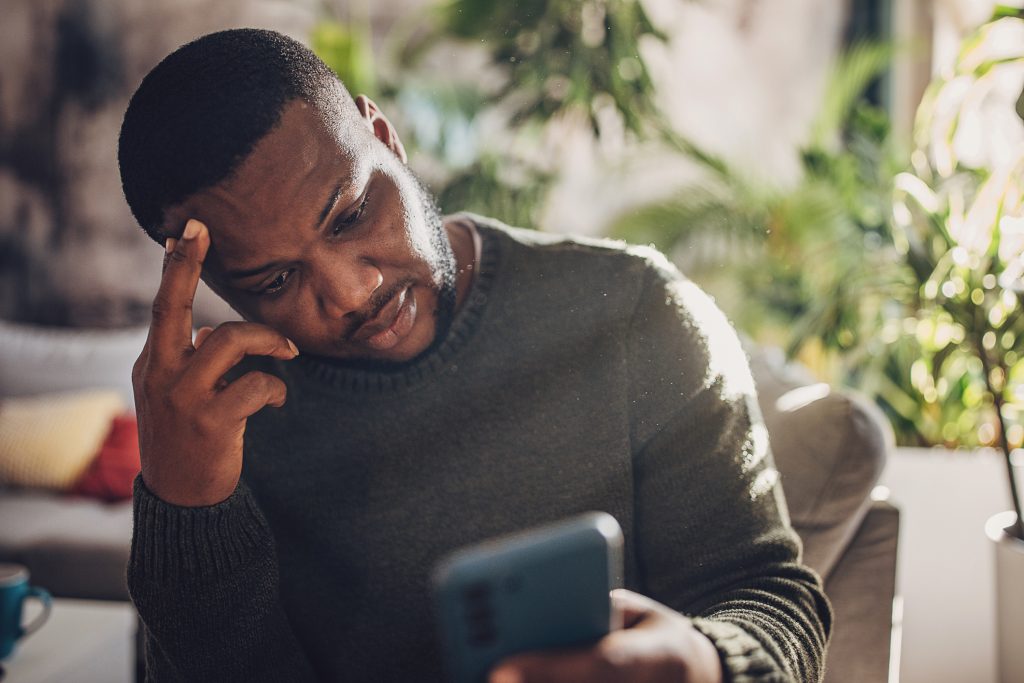 frustrated man looking at his phone
