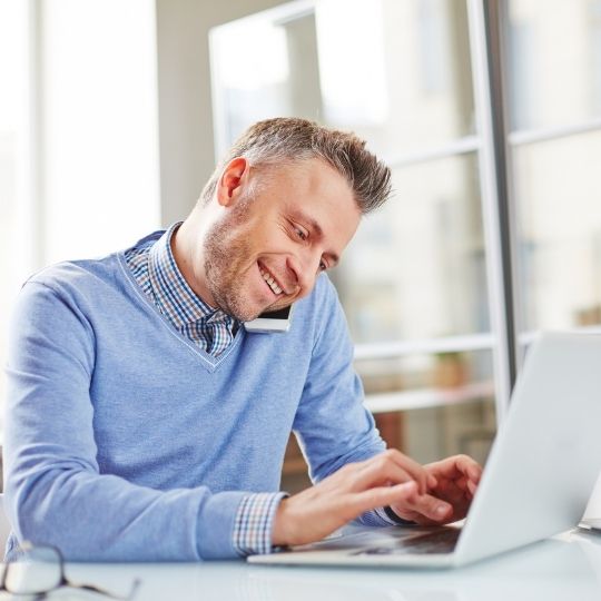 Man on the phone providing assistance to a client.