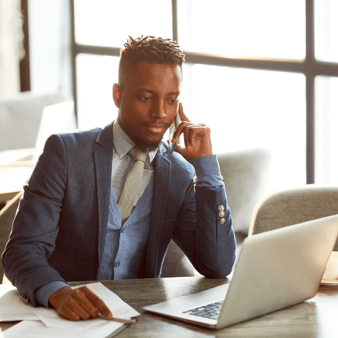 A man talking in the phone and doing work