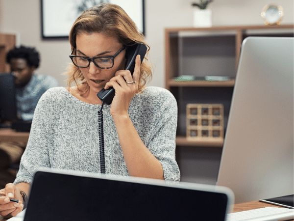 Receptionist on phone as part of answering service team