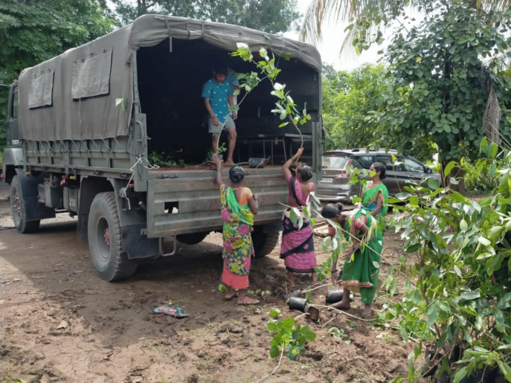 women unloading a truck to plant trees