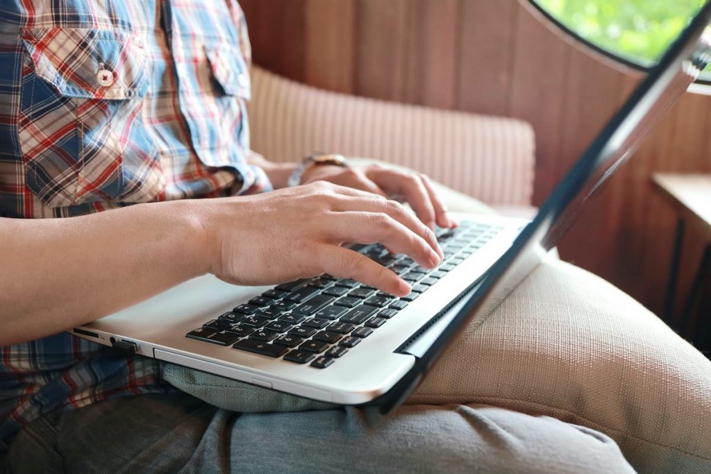 Hands multitasking man working on laptop connecting wifi internet, businessman hand busy using laptop at office desk, finger typing on keyboard laptop with lead capture