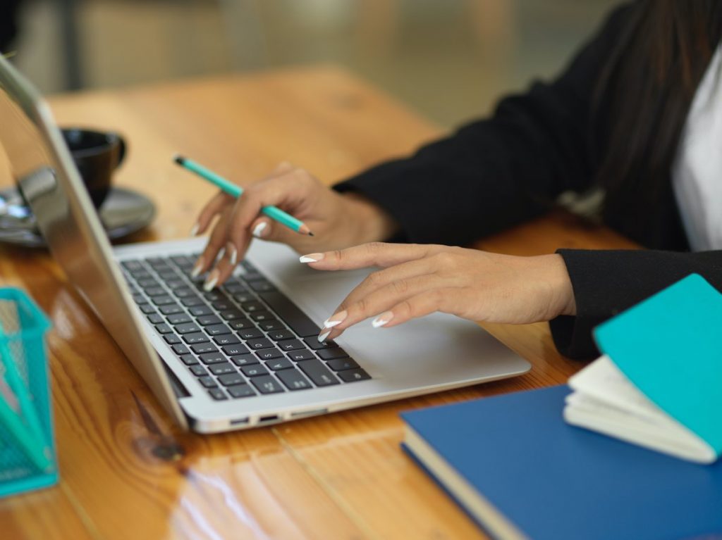 Woman entering details into lead capture fields on laptop