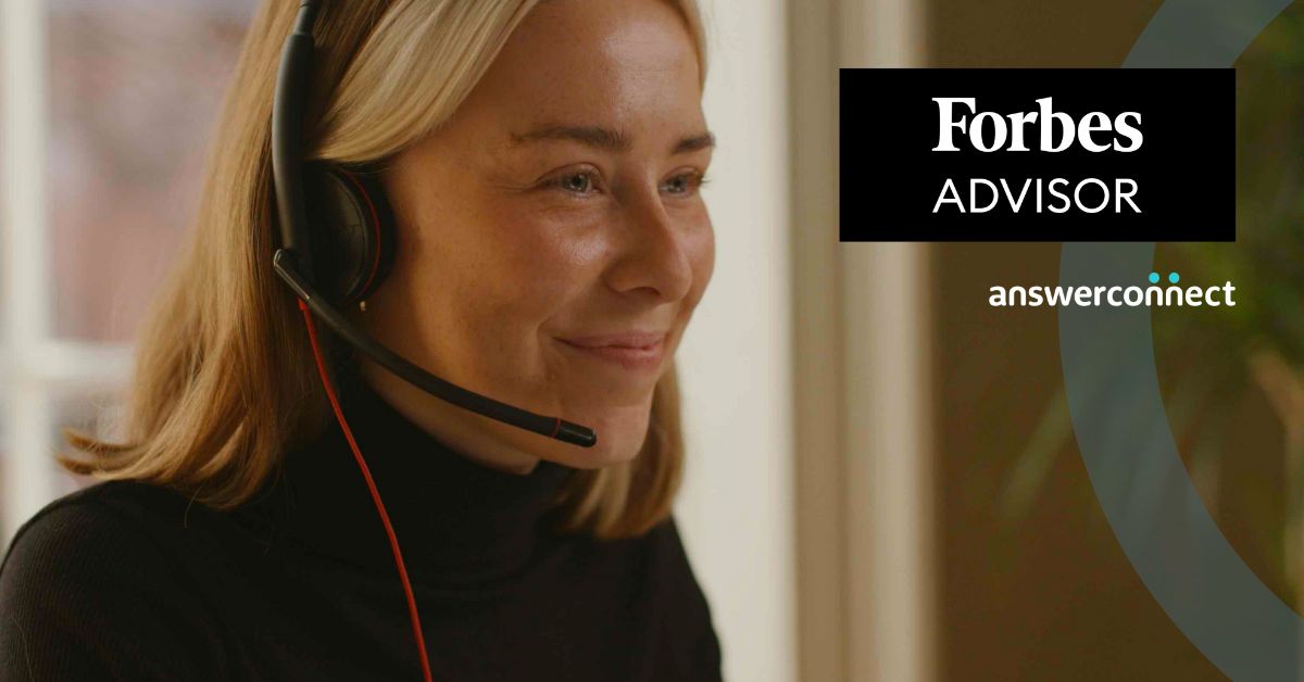 Smiling receptionist with headset and Forbes Advisor logo overlaid