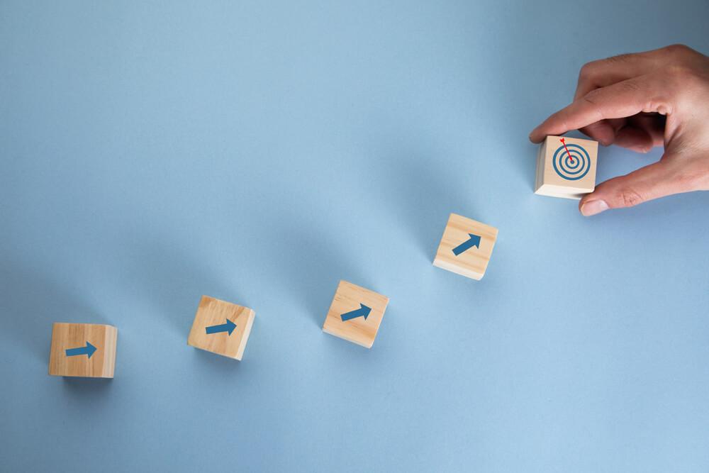 Building blocks pointing to a bullseye shot