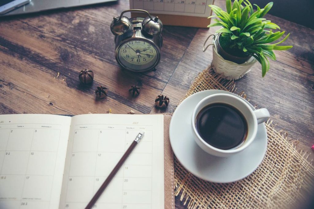 Diary and coffee on table