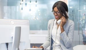 Shot of smiling businesswoman talking on desk phone