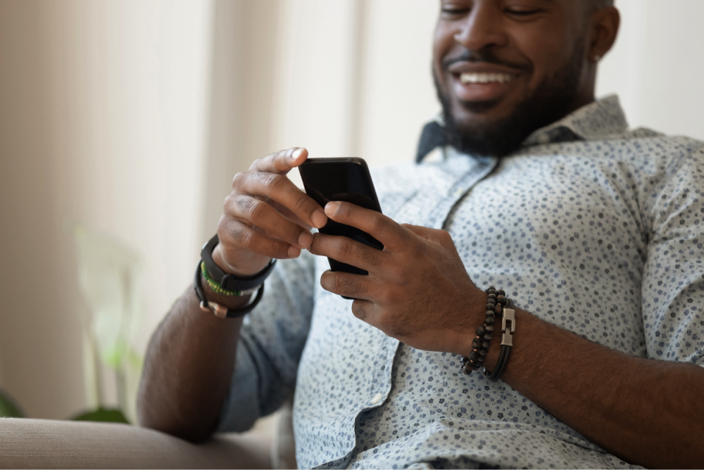 Man smiling at his phone