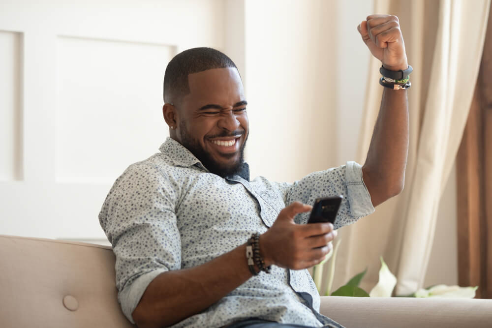 Happy man seeing his phone 