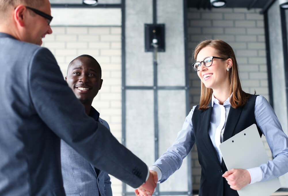 People shaking hands and smiling