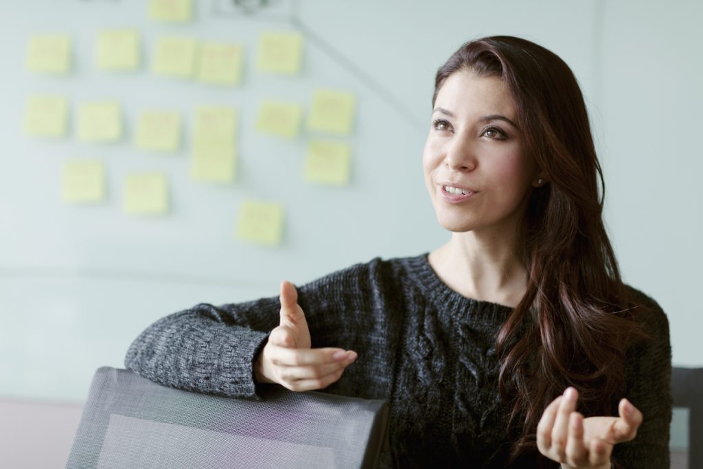 woman in a relaxed business setting in the middle of talking