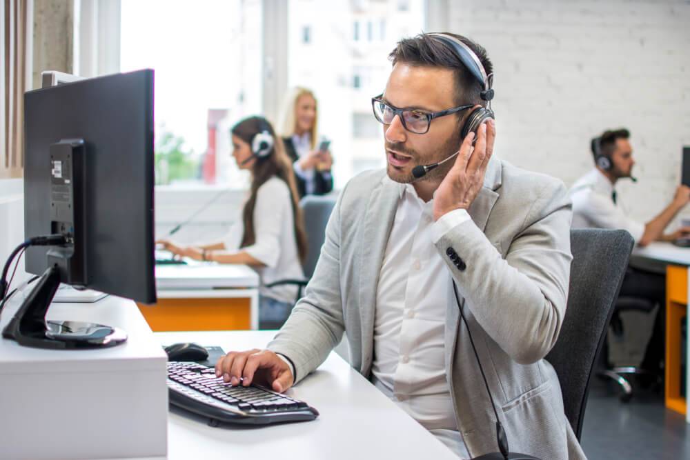 technical support operator with headset taking calls 