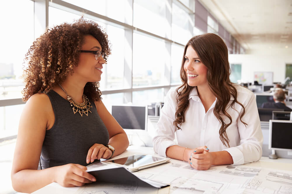 two women working together in office 