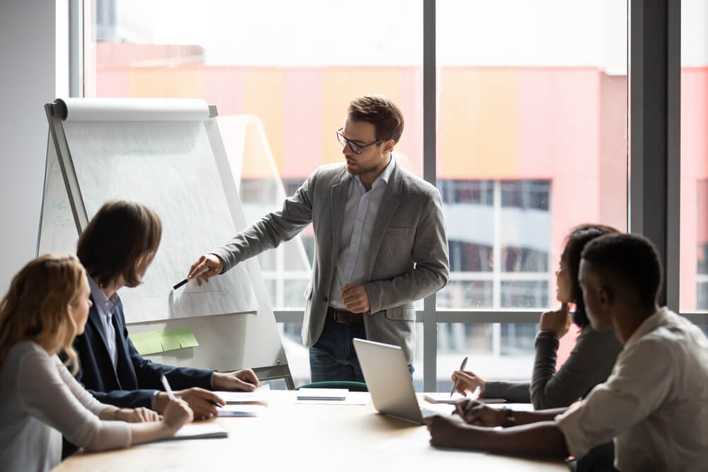 man giving a presentation to his team 