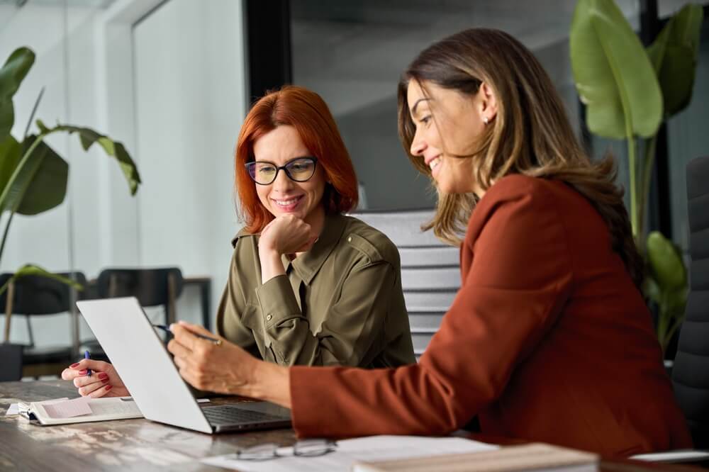 two women colleague discussing about something 