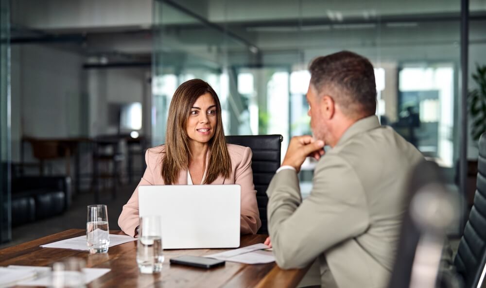 women discussing about a project with a man