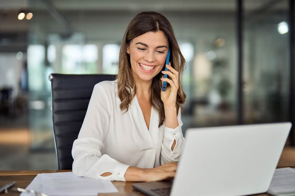 women smiling and talking in the phone 