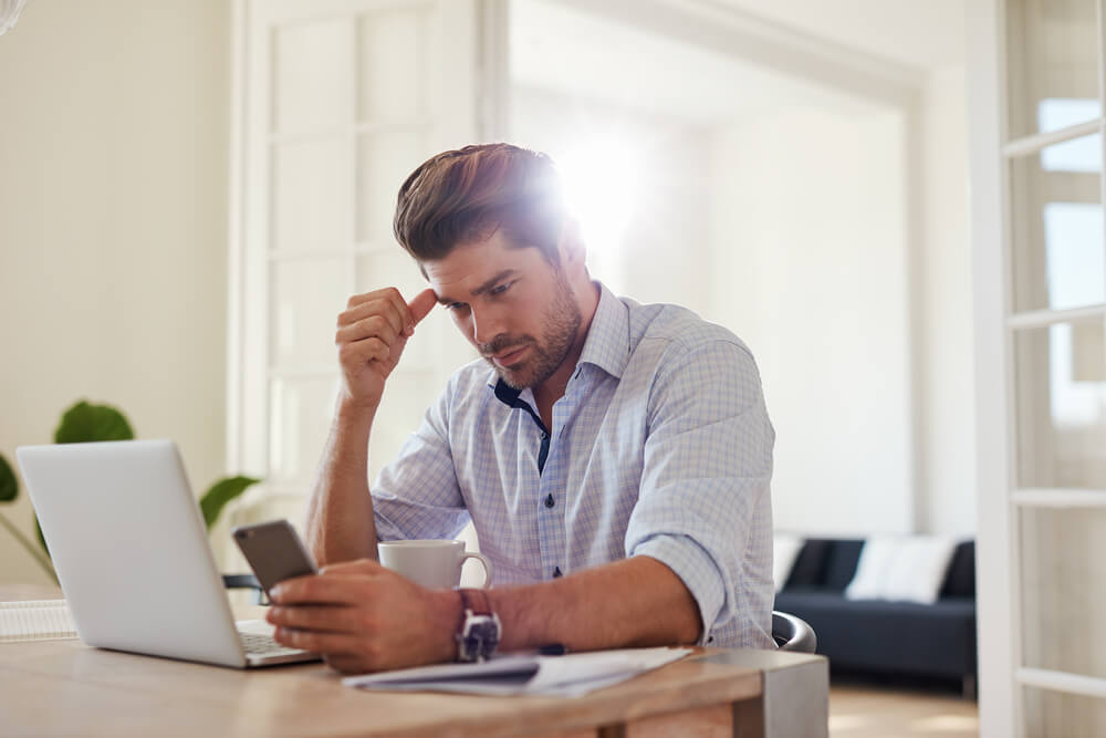 worried man looking in his phone