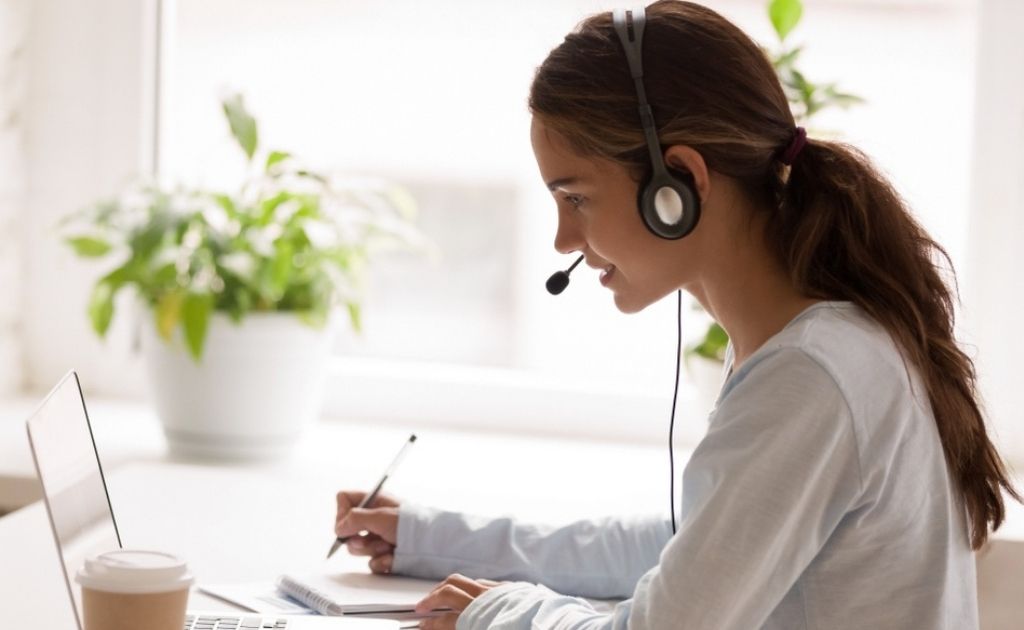 Woman using a headset, working for a telephone answering service